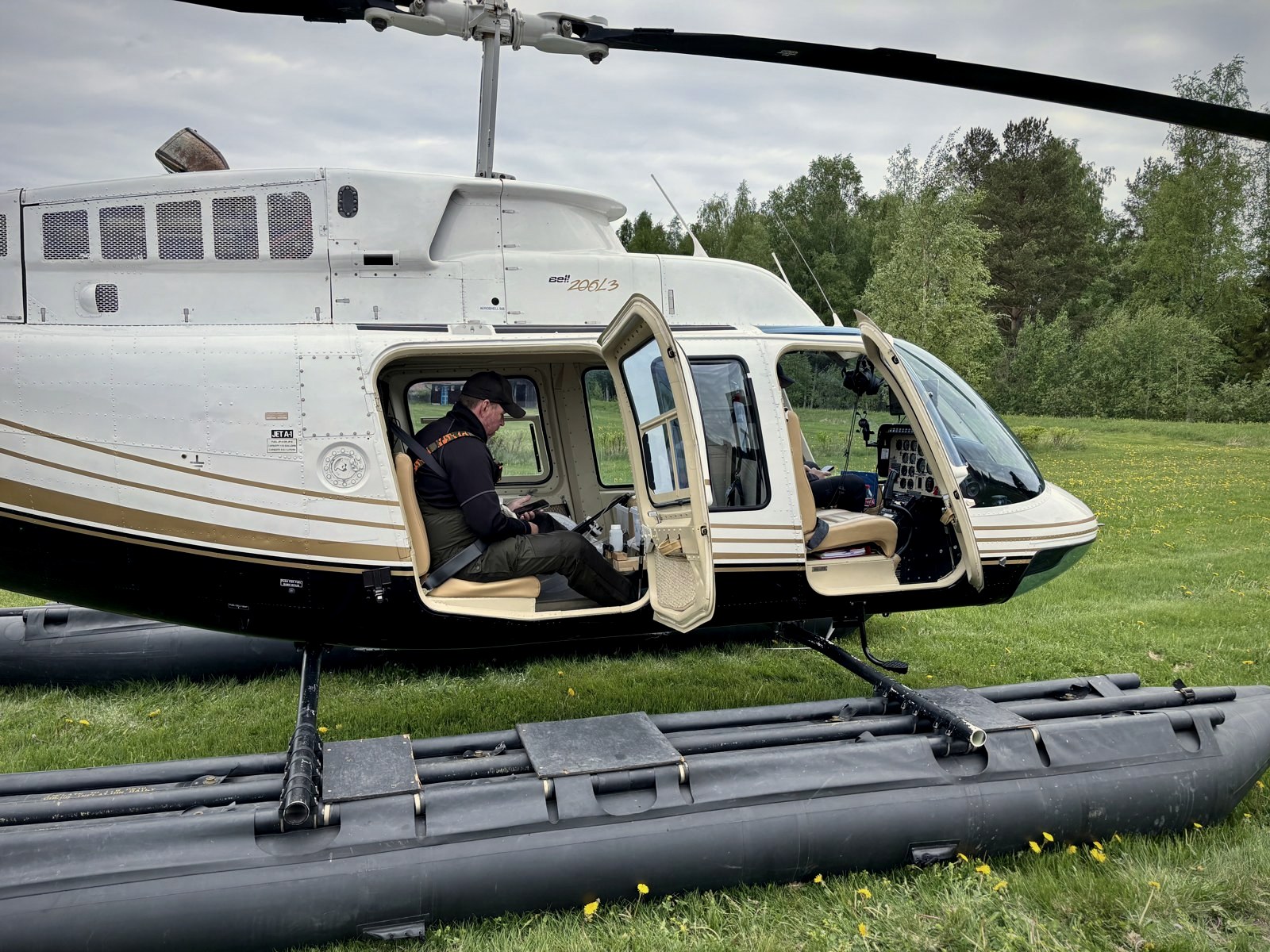 Bell 206L-3 with floats on a grass field
