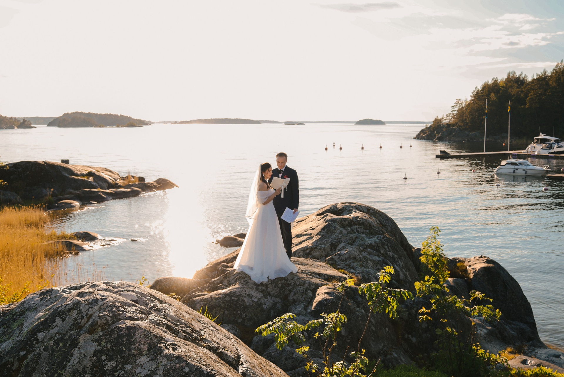 Couple exchanging vows on the rocks at sunset in the archipelago