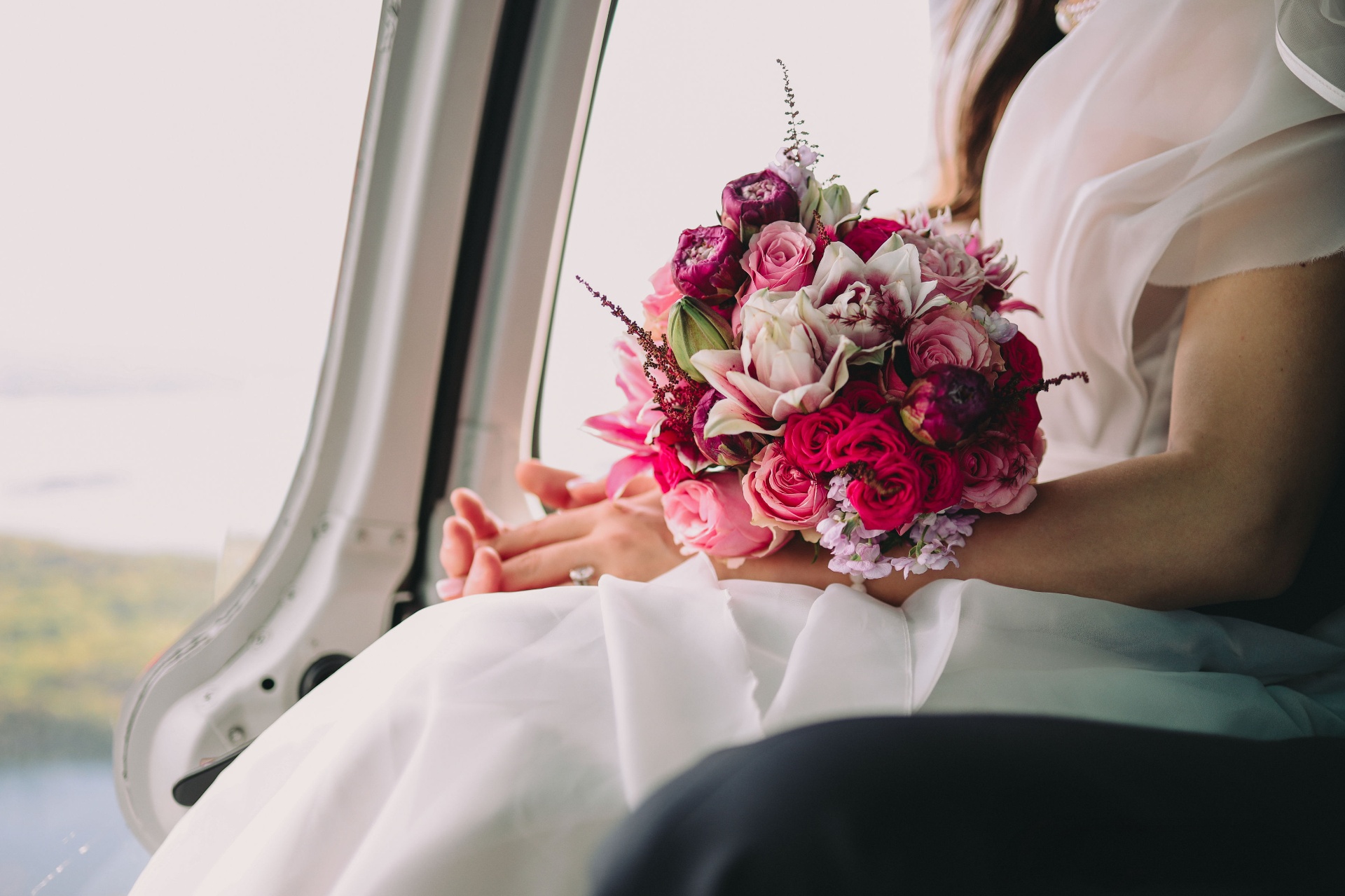 The bride's bouquet with pink and red roses on board the helicopter