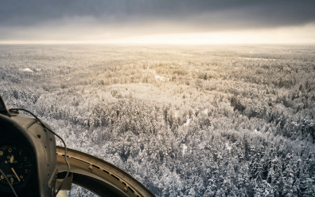 Observer in helicopter during a survey mission