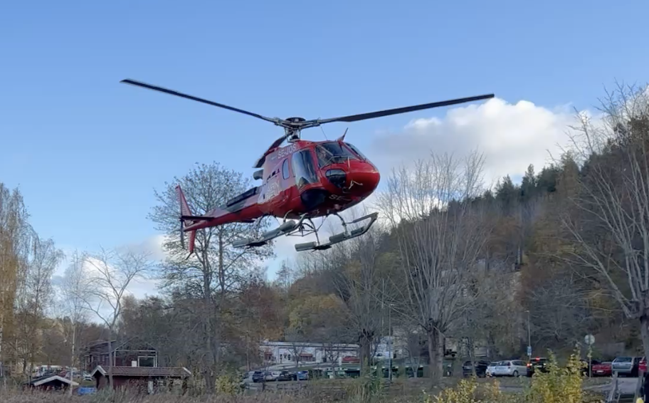 Red helicopter lifting off in Valdemarsvik